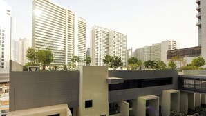 A modern urban building complex with multiple high-rise structures, some with balconies and others with terraces. - Luxury 1BR at Sterling East Burj Views (Dubai)