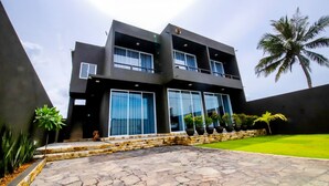 A modern two-story building with large windows and a stone-paved entrance. - Cinnamon Tree Resort Akurala-Hikkaduwa (Madampagama)