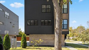 A modern two-story building with a flat roof, large windows, and a brick base. - G St Loft, Downtown Bentonville (Bentonville)