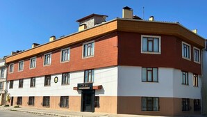 A two-story building with a red and white facade, multiple windows, and a visible entrance. - Casa Liva Otel Eskişehir (Eskişehir)