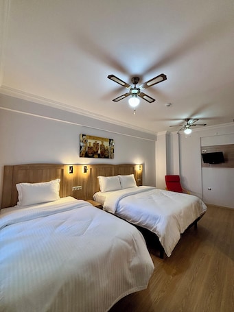 Standard Triple Room, Courtyard View | Minibar, in-room safe, desk, laptop workspace