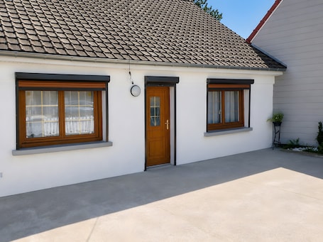 A single-story house with a tiled roof, a front door, and two windows with shutters.. Holiday Home 'Gite618'