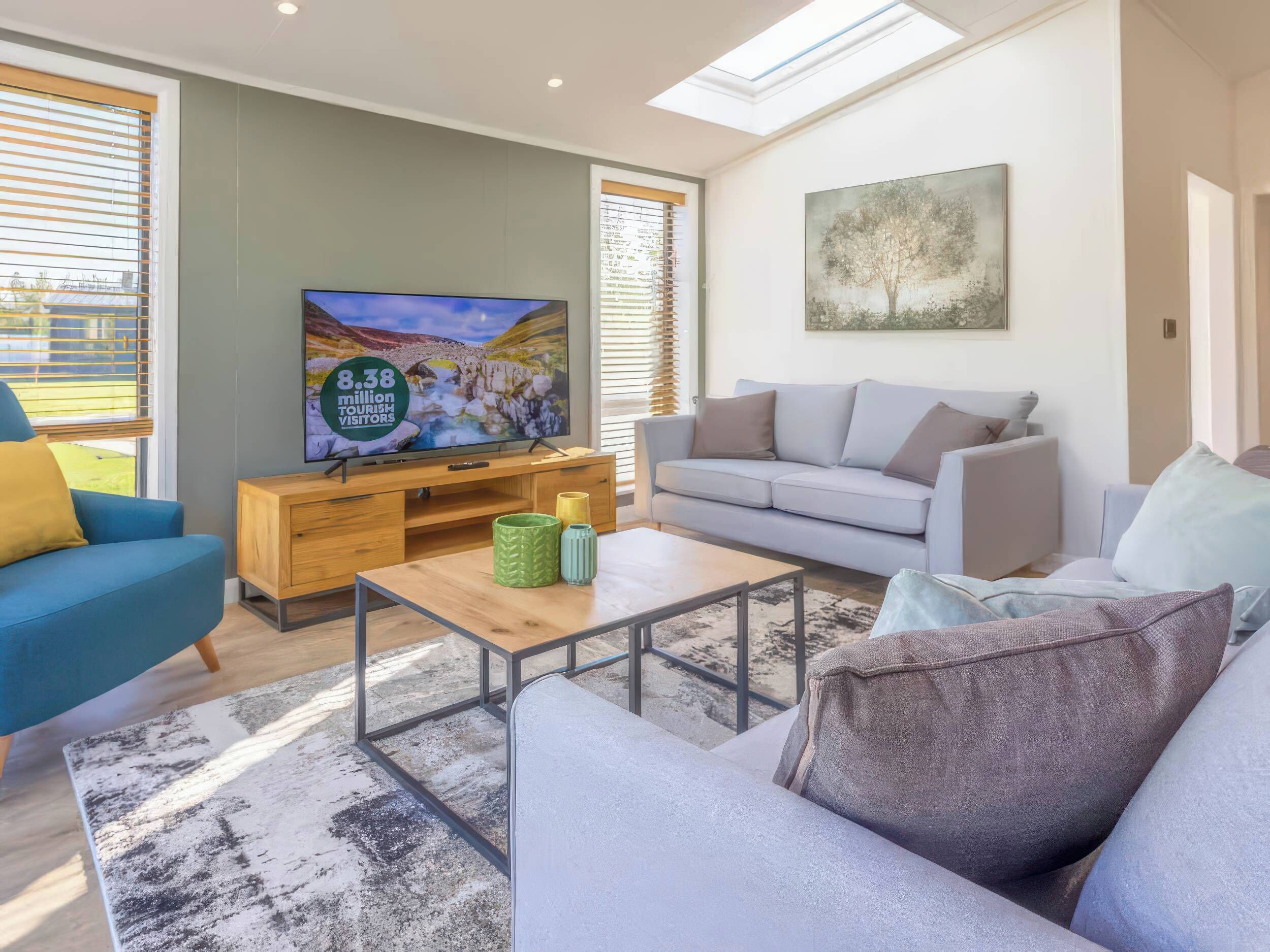 A modern living room with a television, sofa, and coffee table.