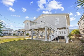 A two-story house with a covered porch and a staircase leading to the upper floor. - 4 Bedroom Home in Cherry Grove, 1 Block From Beach (North Myrtle Beach)