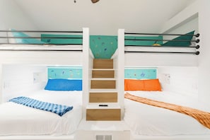 A bunk bed room with a central staircase, white walls, and a ceiling with a mural.