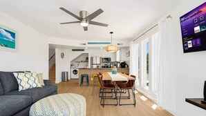 A modern apartment with a dining area, kitchen, and living room. - Beach Buddies 2 w/pool (North Myrtle Beach)