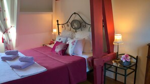 A bedroom with a bed, pillows, a nightstand, a lamp, and a chair. - “Romantic Suite” Guest Room with Shared Terrace & Garden, Wi-Fi (Honfleur)