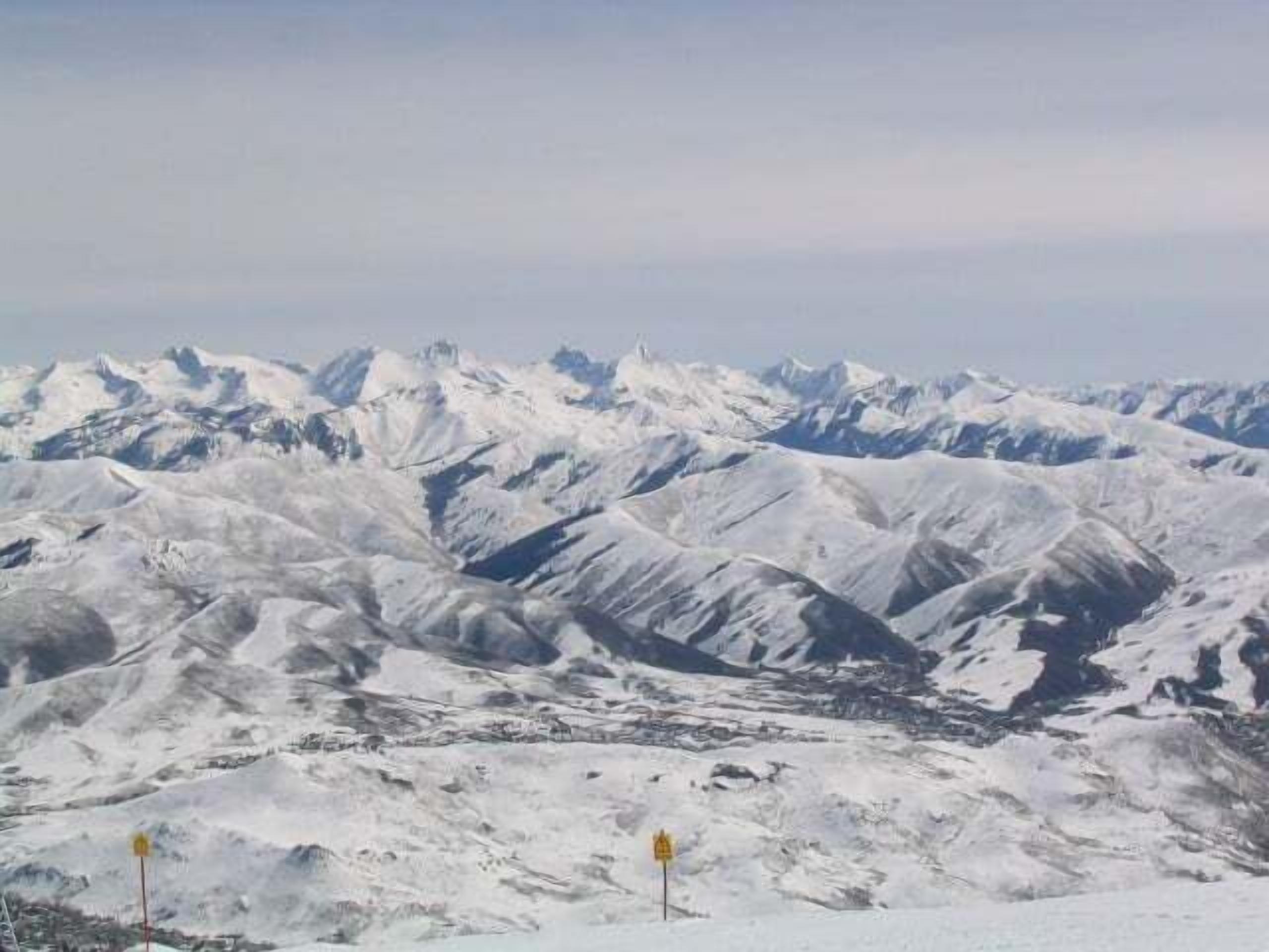 A snow-covered mountain range with a clear sky.