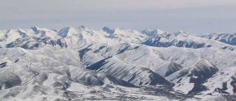 A snow-covered mountain range with a clear sky.