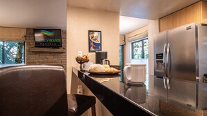 A modern kitchen with a stainless steel refrigerator, a coffee maker, and a bowl of fruit on the counter. - Sv139 - Walk to Lifts & Town - Hot Tub & Pool (Ketchum)