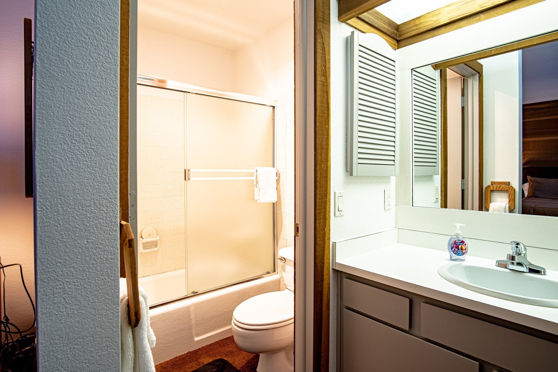 A bathroom with a bathtub, toilet, and sink.