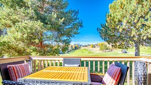 A deck with wicker furniture and a view of a golf course. - Ridge Condo - Luxury Condo W/resort Amenities (Sun Valley)