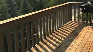 A wooden deck with a railing overlooking a forested mountain area. - Sv112 - Walk to Lifts & Town - Hot Tub & Pool (Ketchum)