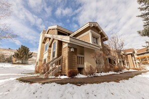 A two-story house with a prominent front staircase, large windows, and a snow-covered landscape. - Sunburst in Sun Valley! Modern Family Getaway in Elkhorn (Sun Valley)