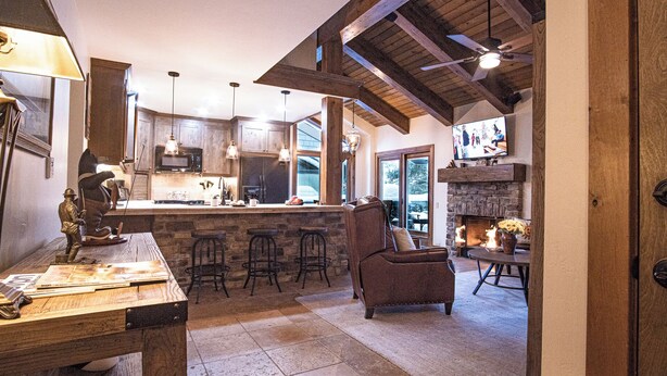 A spacious kitchen with a stone island, bar stools, and a fireplace. - Sv154 - Walk to Lifts & Town - Hot Tub & Pool (Ketchum)