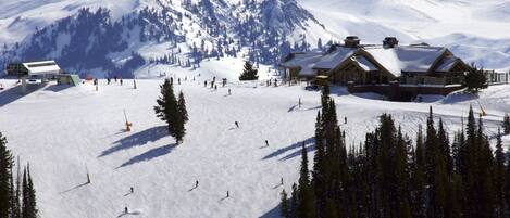 A ski resort with multiple lodges, ski slopes, and a mountainous backdrop.