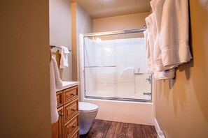 A bathroom with a glass shower enclosure, a toilet, and wooden cabinetry. - 3BD Downtown Ketchum Ski Condo - Near Ski Lifts (Ketchum)