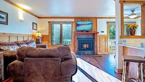 A cozy living room with a fireplace, a television mounted above it, and a sofa. - Sv109 - Walk to Lifts & Town - Hot Tub & Pool (Ketchum)