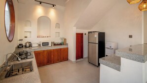 A modern kitchen with granite countertops, a built-in oven, a refrigerator, and a sink. - 3 bed room Villa Rice View Terrace in Bali (Sukawati)