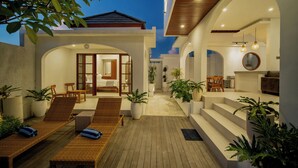 A modern house with a wooden deck, outdoor seating, and potted plants. - 3 bed room Villa Rice View Terrace in Bali (Sukawati)