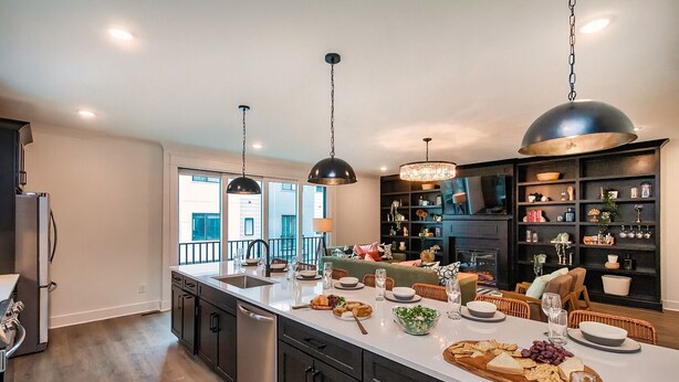 A modern kitchen with a central island, dark cabinetry, and pendant lighting. - ♨️🌃 Hot Tub Heaven A, B, C&D @ The Gulch (Nashville)