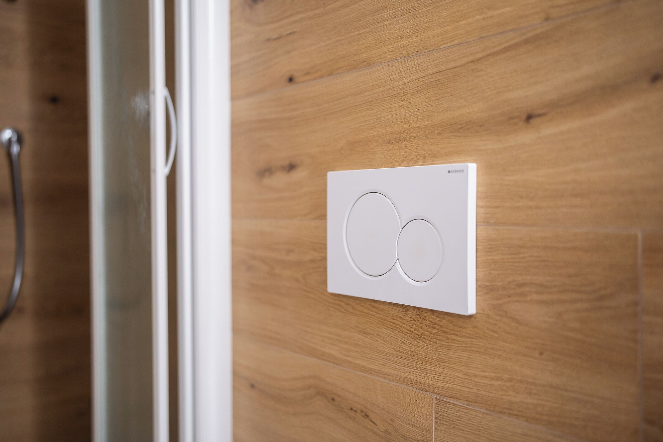 A thermostat mounted on a wooden wall.