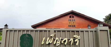 Un bâtiment doté d’une façade en bois et d’une enseigne avec un texte grand et stylisé.