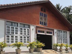 A two-story building with large windows and a tiled roof. - Phenwaree Amphawa Resort by Zuzu (Samut Songkhram)