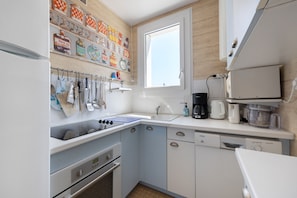 A modern kitchen with a built-in oven, a microwave, and a coffee maker.