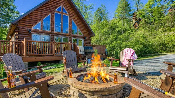 A log cabin with a deck, outdoor seating, and a fire pit. - Ridge Hollow Retreat – Hot Tub, Fire Pit, Dogs (Gatlinburg)