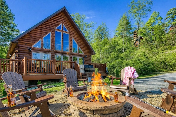Gather around the cozy fire pit with Adirondack chairs, nestled in front of the cabin—perfect for evening conversations, laughter, and Smoky Mountain memories under the stars.