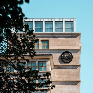 A building with a modern architectural style, featuring a prominent circular logo on the facade. - B&B HOTEL Wrocław Old Town (Wrocław)