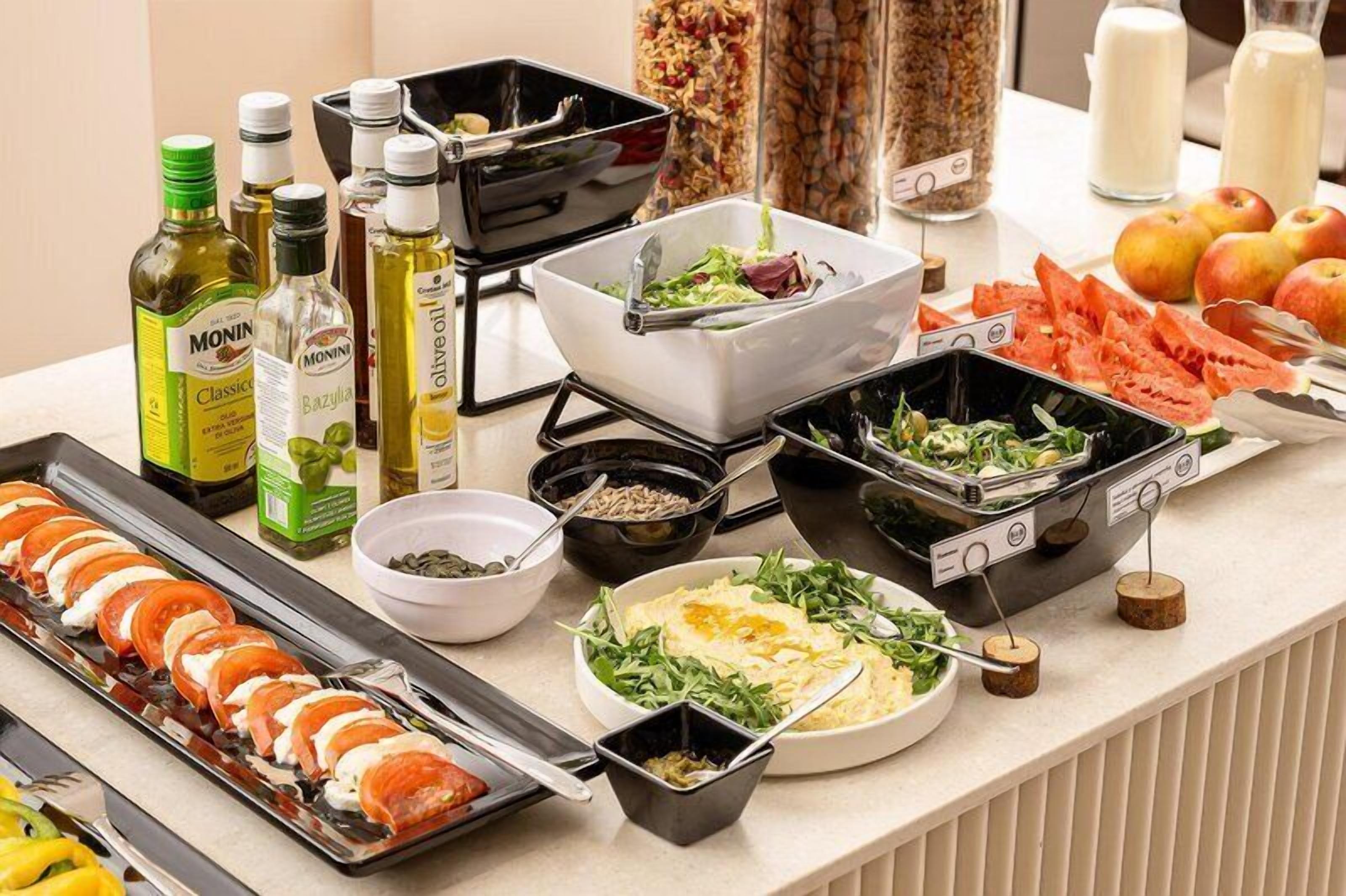 A buffet with various food items, including seafood, salads, and vegetables.