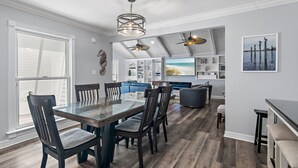 A modern kitchen with a large island, built-in appliances, and a view to the backyard.