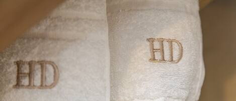 A white towel with embroidered letters "HD" on it.