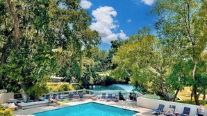 A swimming pool with lounge chairs and a waterfall feature. - Fairway View Getaway in Palmetto Dunes (Hilton Head Island)
