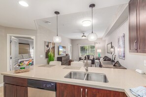 A modern kitchen with a double sink, a dishwasher, and pendant lights. - Beautiful Resort-Style Condo in Desert Ridge, Phoenix. . .Comfy King Size Bed! (Phoenix)