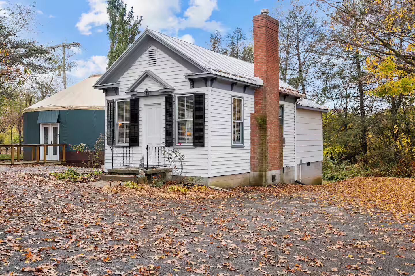 A small, single-story building with a gabled roof and a brick chimney.