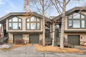 A modern two-story building with large windows and a stone facade. - Private Hot Tub & Garage, Near Main St/Peak 9 (Breckenridge)