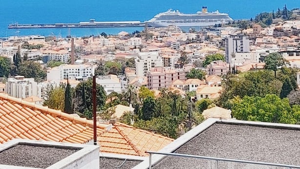 A coastal cityscape with a cruise ship in the distance, buildings, and a clear blue sky. - Sea View 2 Bedrooms Terrace Villa (Funchal)