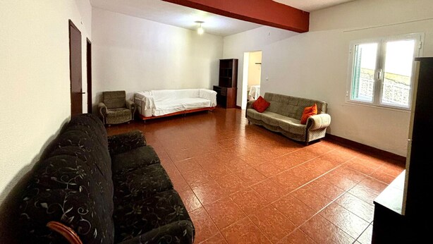 A spacious living room with a high ceiling, a sofa, a couch, and a window with a view. - Sea View Madeira Machico 2 Bedrooms Terrace Villa (Machico)