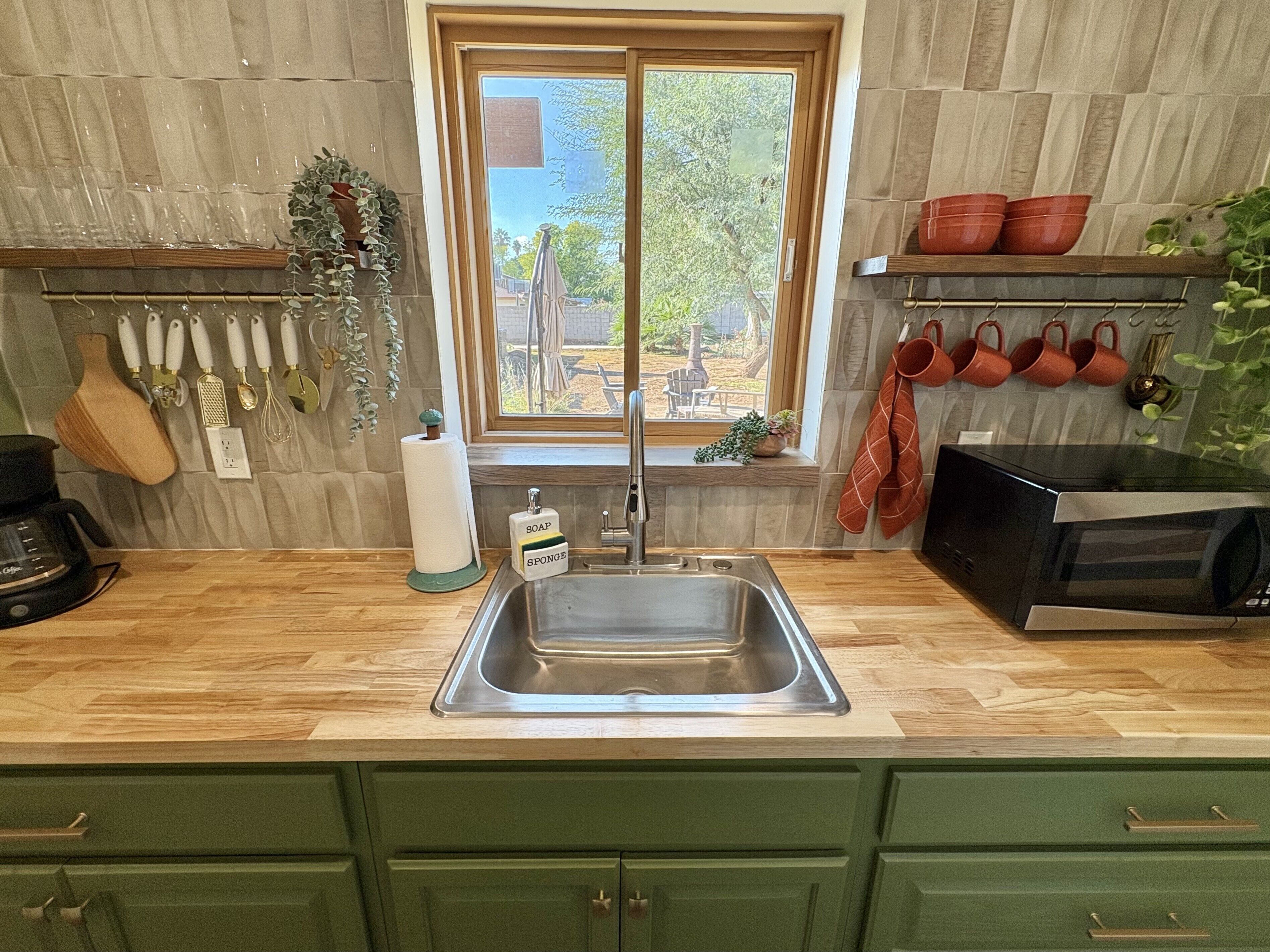 Fridge, microwave, coffee/tea maker, cookware/dishes/utensils