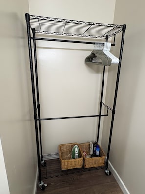 A metal storage unit with shelves and baskets. - The Little Adobe - Daniel & Clara Boone Historic Bunkhouse in Central Phoenix! (Phoenix)
