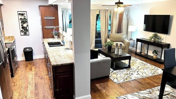 A modern kitchen with wooden cabinets, a built-in oven, and a sink. There is a dining area with a table and chairs, and a living room with a sofa and a coffee table. - Spacious  2BD Condo  HWY360/30  Grand Prairie (GP22B) (Grand Prairie)