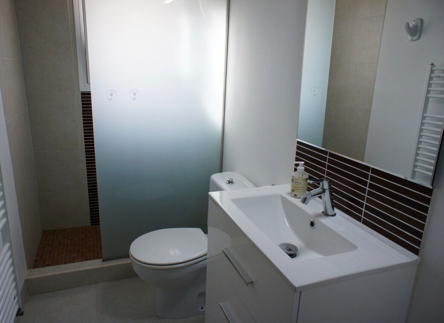 Ein Badezimmer mit Toilette, Waschbecken und Dusche.