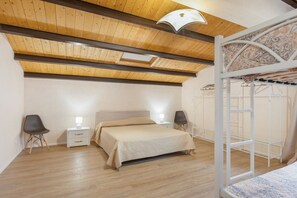 A bedroom with a bed, bedside tables, a hanging chair, and a wardrobe. - Apartment 'N8' with Shared Pool, Balcony and Air Conditioning (Vittoria)