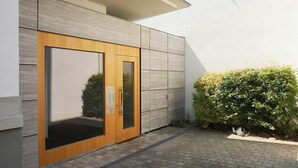 A modern building with a wooden door and a keypad lock. - KÖNIGSschlafs cuddly nest for 2 persons with sunny balcony (Konstanz)