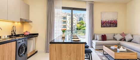A modern apartment with a kitchen, dining area, and living room.