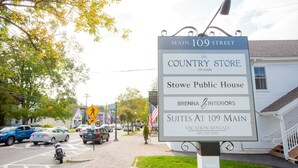 A sign for The Country Store on Main 109 Street, Stowe Public House, Brenna Interiors, and Suites at 109 Main. - Pinnacle Suite at 109 Main (Stowe)