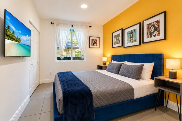 A bedroom with a bed, curtains, a window, wall art, and a bedside table. - Prime Location | Free Parking |By Nightlife & Eats (Miami)